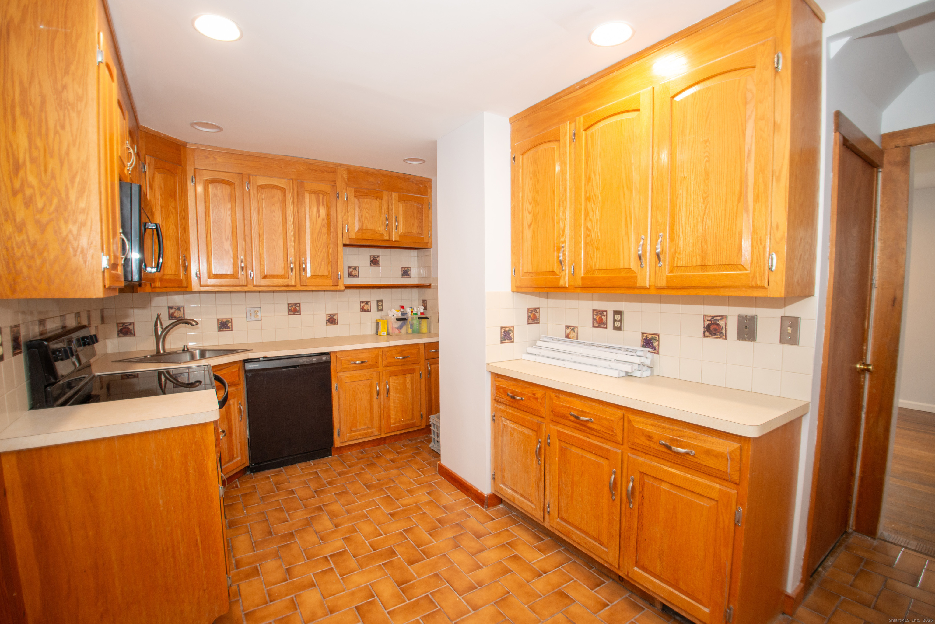 38 Wayland Road Milford, CT 06460 - Photo 18 of 39 a large kitchen with stainless steel appliances a sink window and cabinets