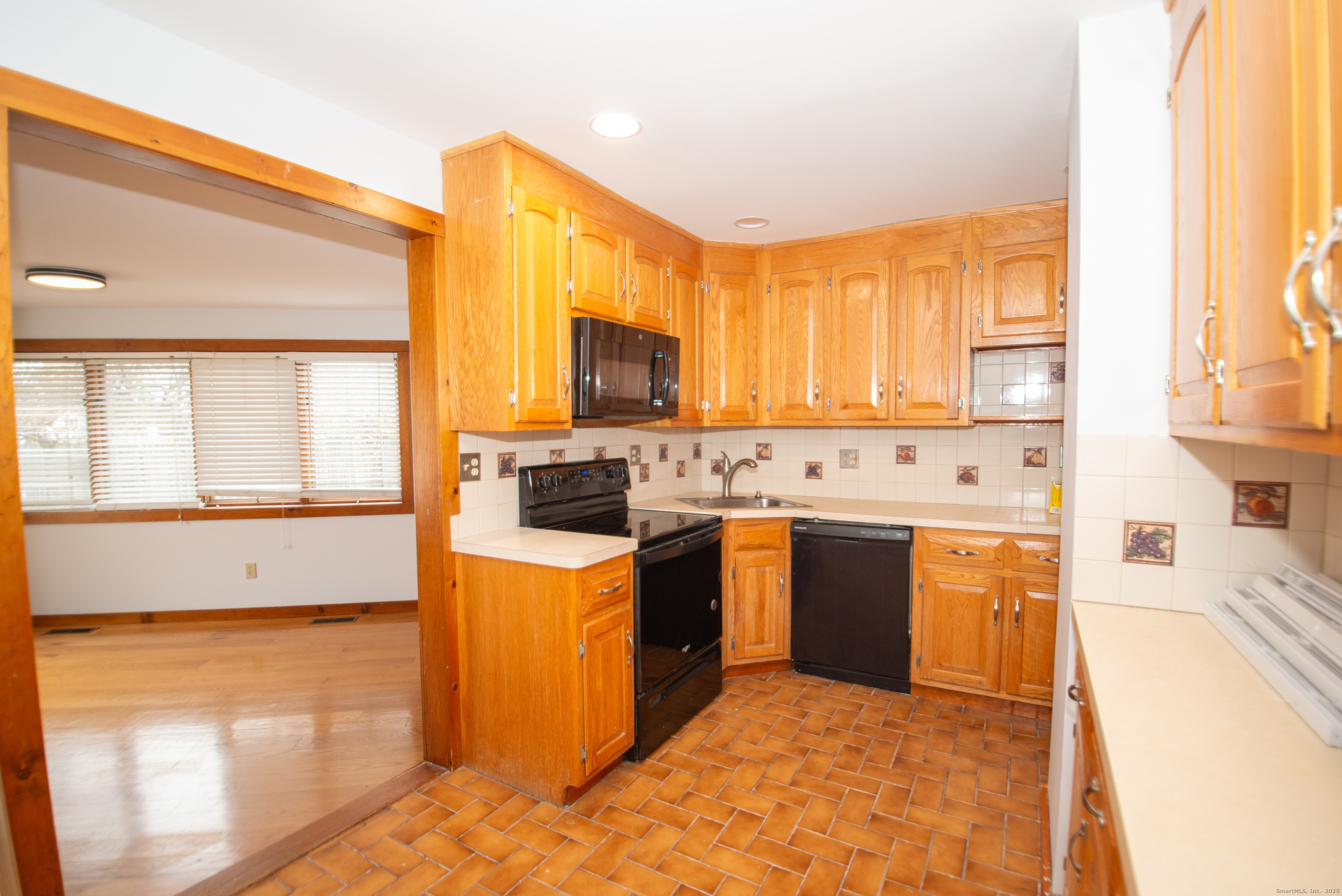 38 Wayland Road Milford, CT 06460 - Photo 19 of 39 a kitchen with a window a sink and a stove top oven