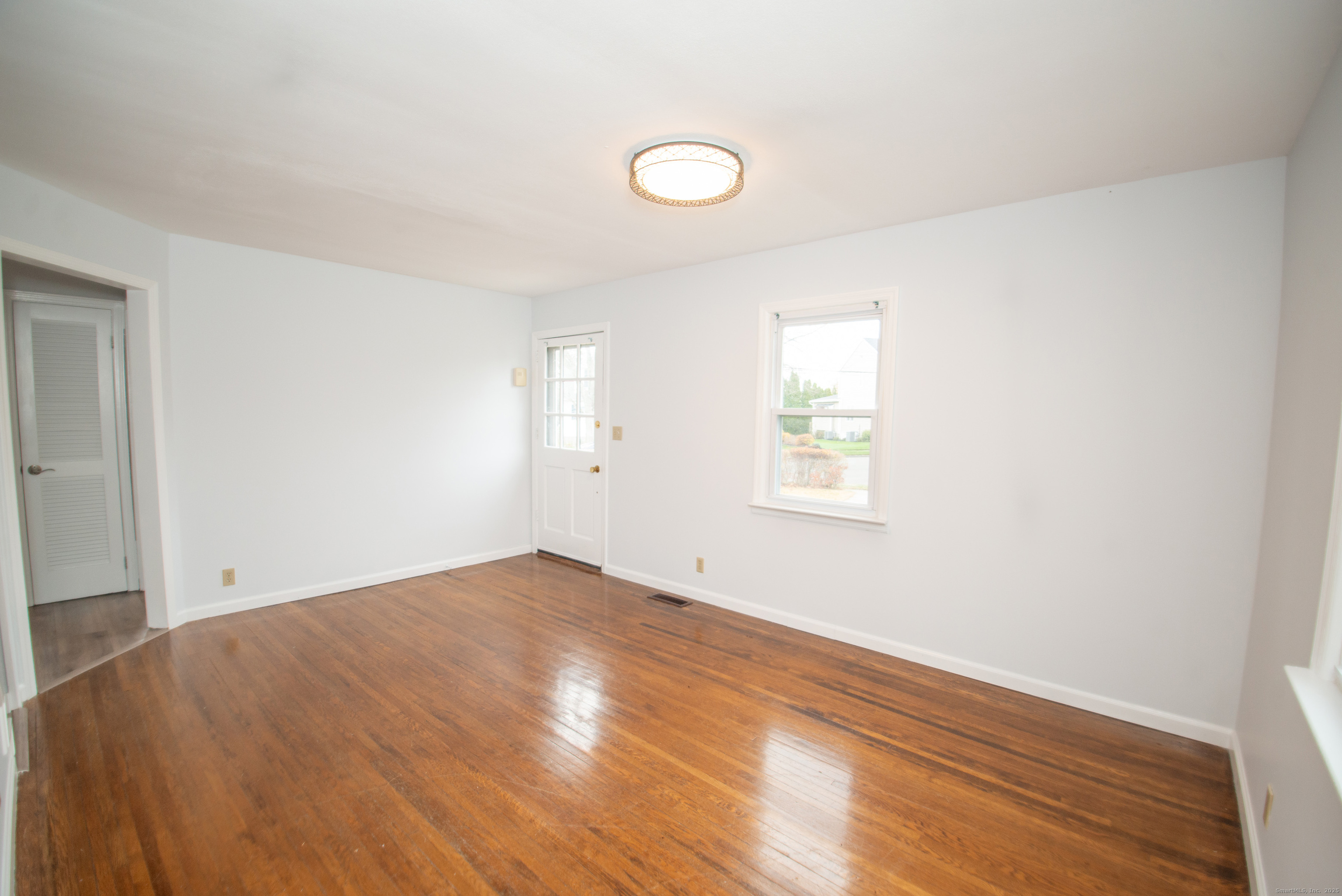 38 Wayland Road Milford, CT 06460 - Photo 21 of 39 an empty room with wooden floor and windows