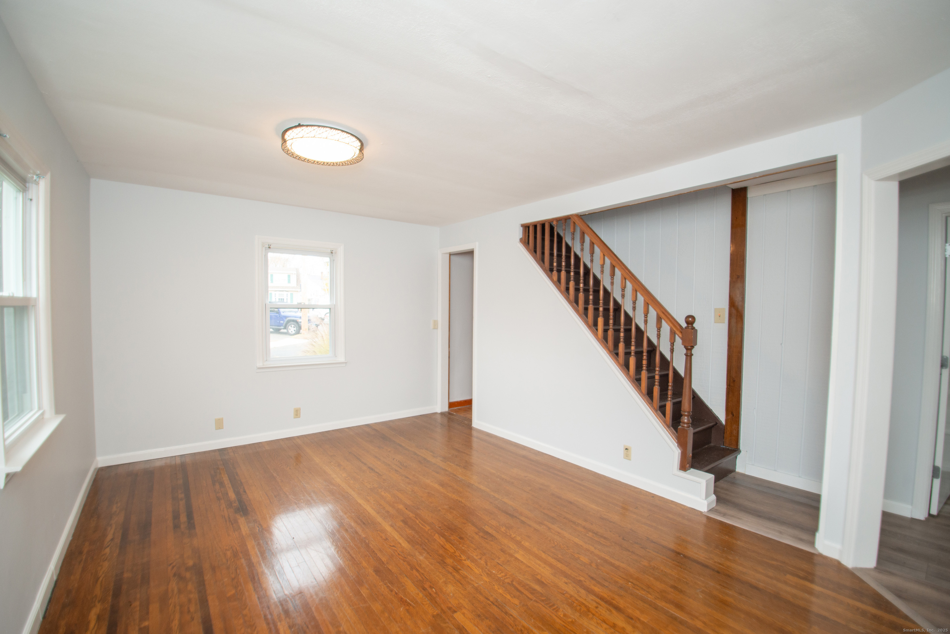 38 Wayland Road Milford, CT 06460 - Photo 23 of 39 wooden floor in an empty room with a window and wooden floor