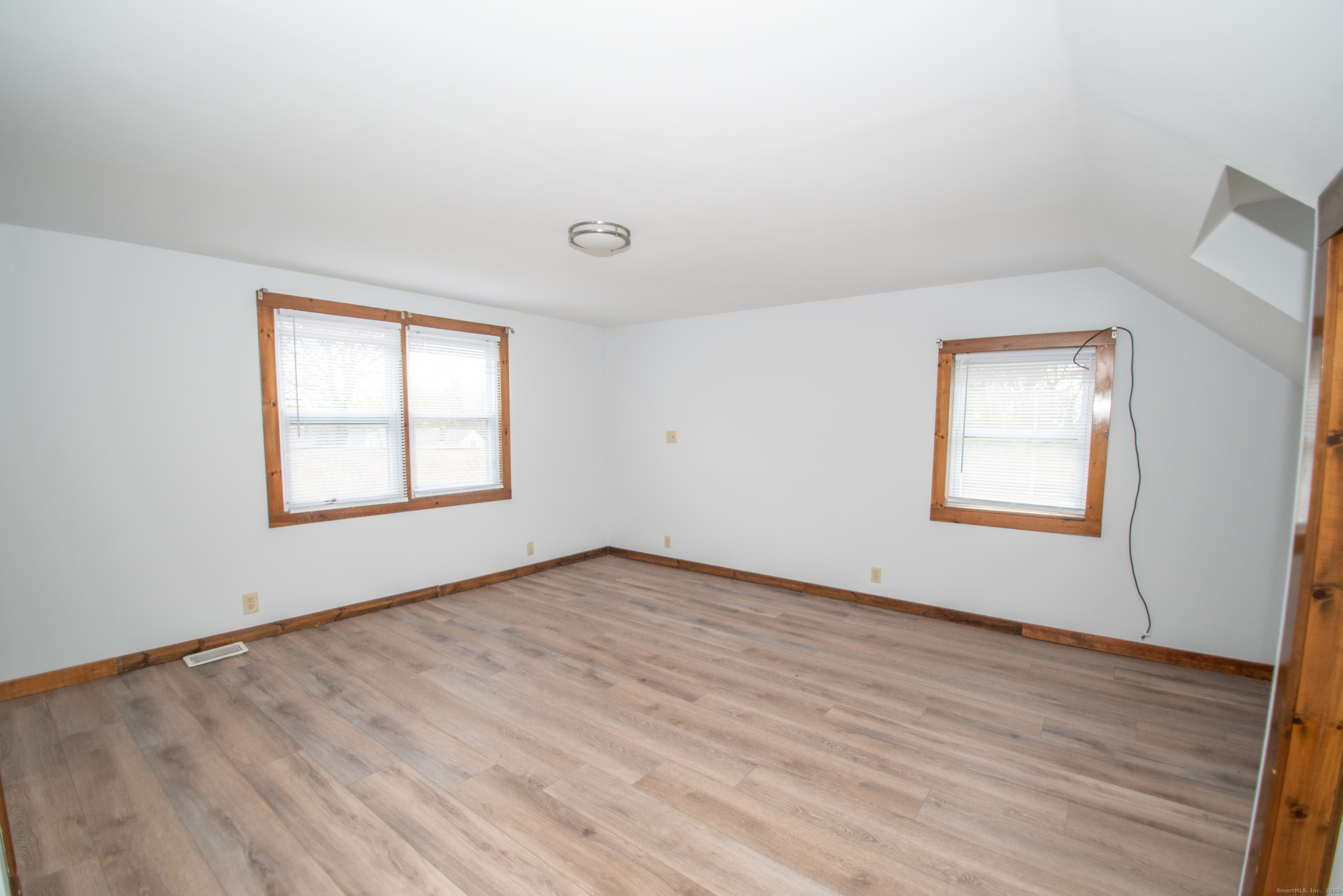 38 Wayland Road Milford, CT 06460 - Photo 34 of 39 an empty room with wooden floor and windows