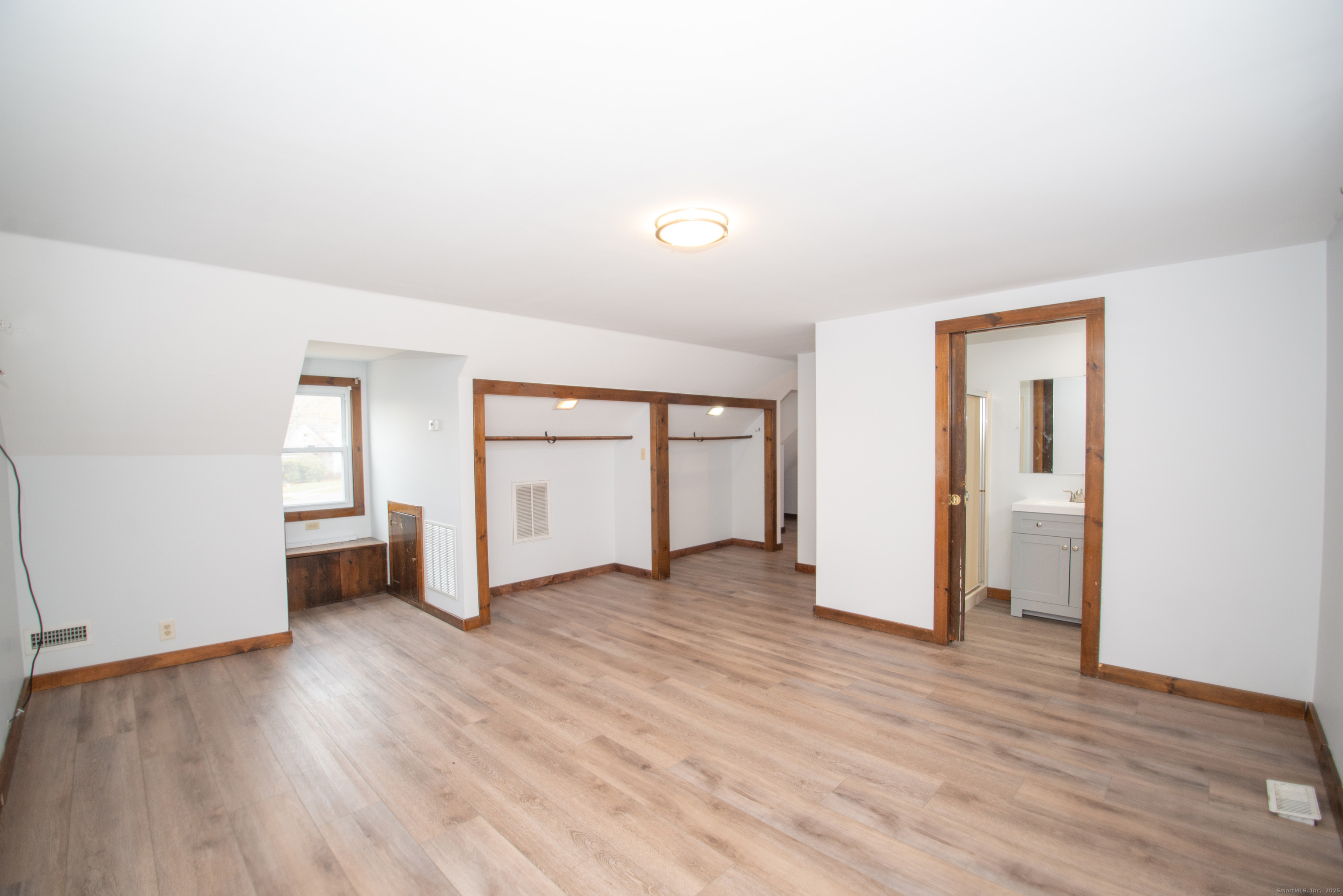 38 Wayland Road Milford, CT 06460 - Photo 36 of 39 an empty room with wooden floor and windows