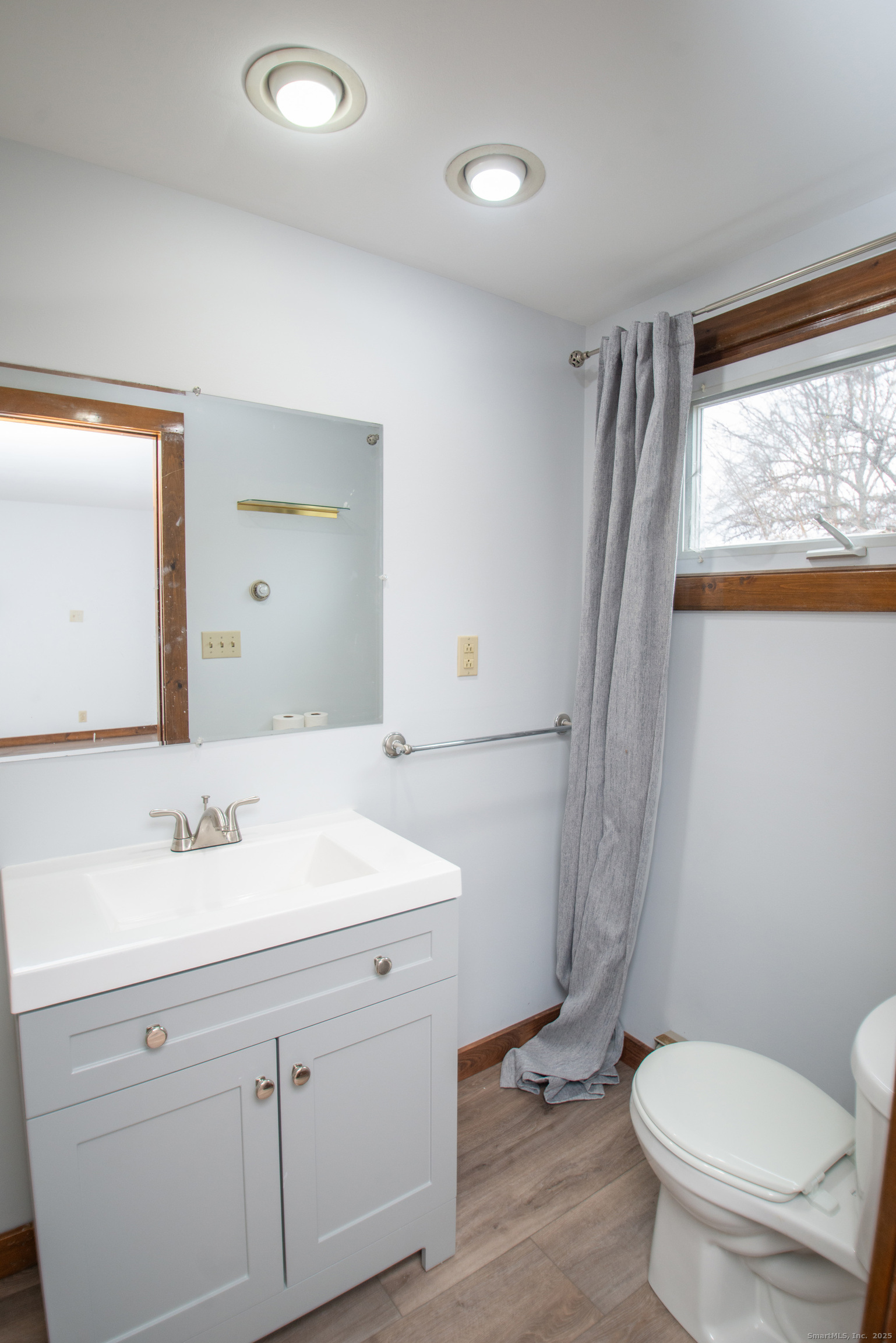 38 Wayland Road Milford, CT 06460 - Photo 38 of 39 a bathroom with a sink toilet a mirror and shower