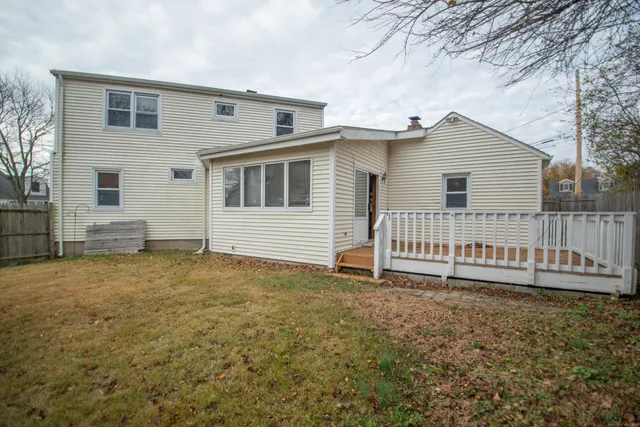 a backyard of a house with table and chairs