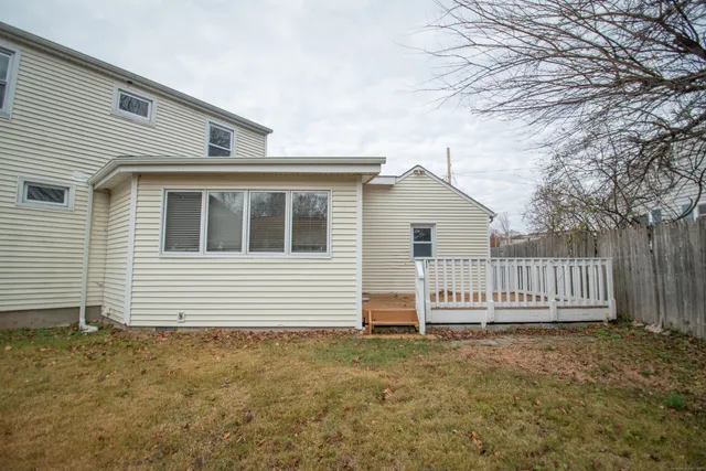 a view of a house with wooden fence