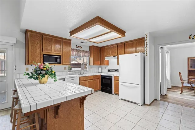 a kitchen with a table and chairs