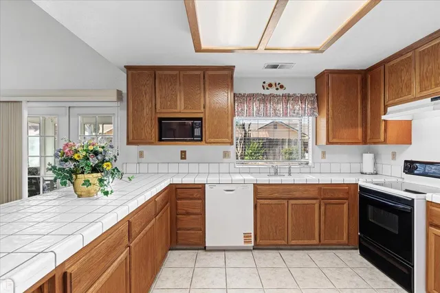 a kitchen with a sink counter top space and cabinets