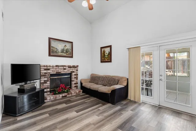 a view of a livingroom with an empty space and a ceiling fan kitchen view