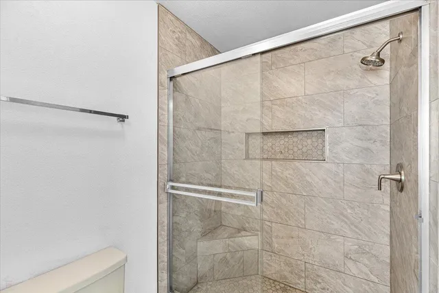 a dining room with furniture large windows and a chandelier