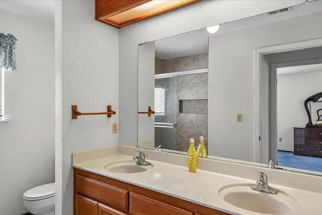 a view of a house with a yard and potted plants