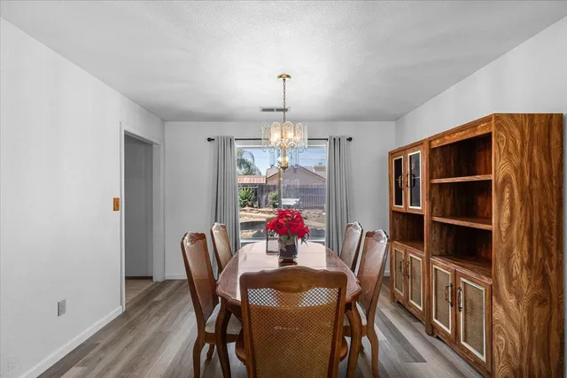 a view of a dining room with furniture and chandelier