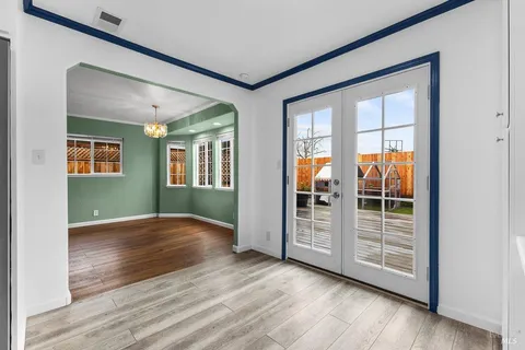 a view of an empty room with window and fire place