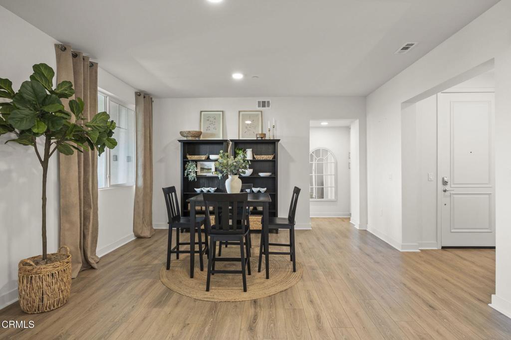 2870 Wagon Wheel Road, Unit 401 Oxnard, CA 93036 - Photo 11 of 49 a view of a dining room with furniture and a potted plant