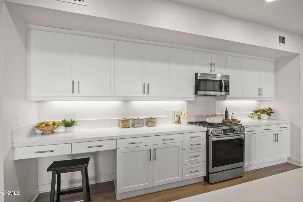 2870 Wagon Wheel Road, Unit 401 Oxnard, CA 93036 - Photo 17 of 49 a kitchen with cabinets appliances a sink and a counter