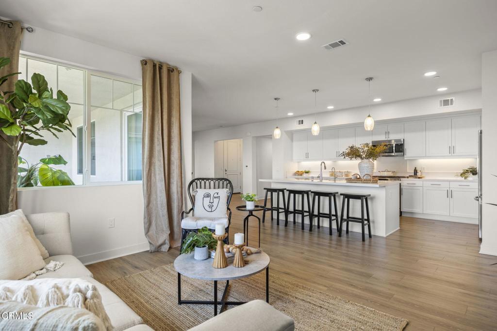 2870 Wagon Wheel Road, Unit 401 Oxnard, CA 93036 - Photo 18 of 49 a living room with furniture and a wooden floor
