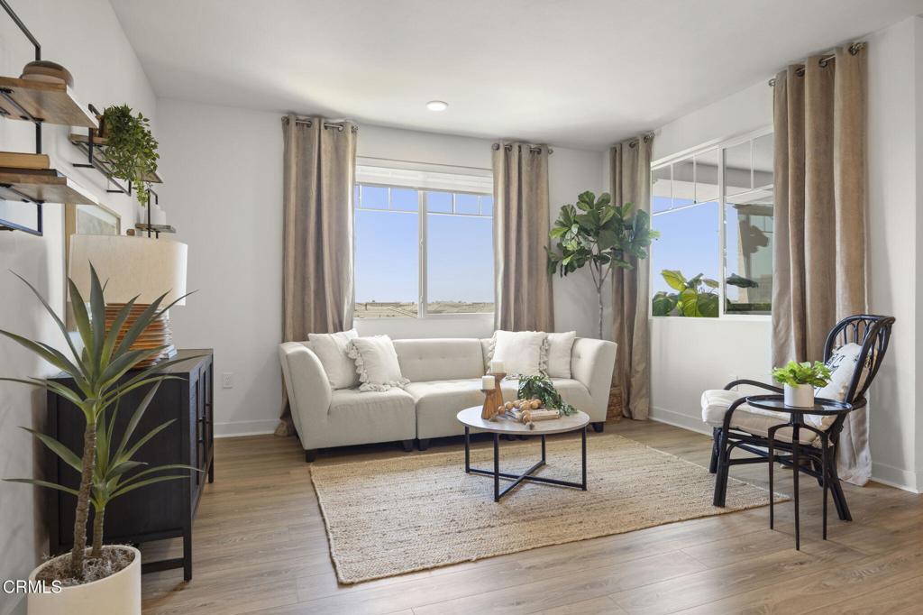 2870 Wagon Wheel Road, Unit 401 Oxnard, CA 93036 - Photo 19 of 49 a living room with furniture and wooden floor