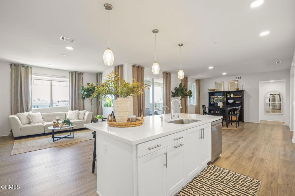 2870 Wagon Wheel Road, Unit 401 Oxnard, CA 93036 - Photo 2 of 49 a living room with furniture and a wooden floor