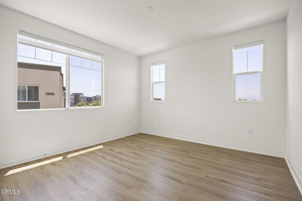 2870 Wagon Wheel Road, Unit 401 Oxnard, CA 93036 - Photo 23 of 49 a view of an empty room with wooden floor and a window