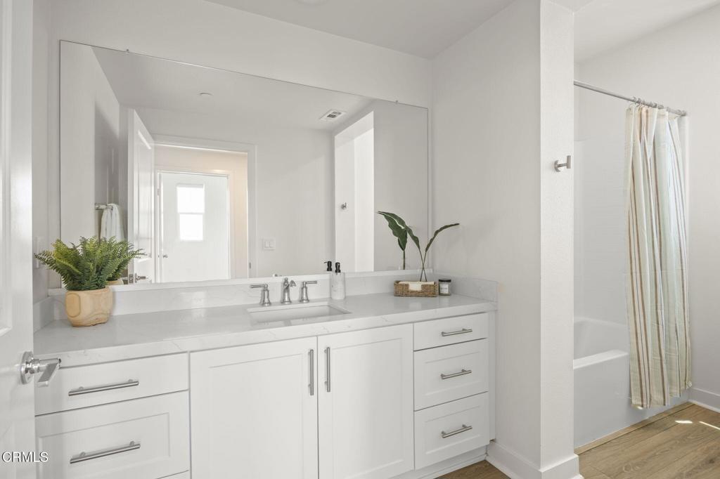2870 Wagon Wheel Road, Unit 401 Oxnard, CA 93036 - Photo 25 of 49 a bathroom with a double vanity sink and a mirror