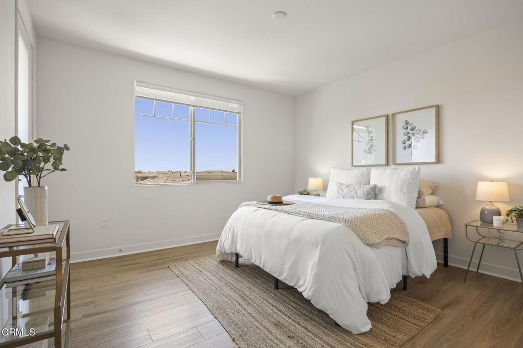 2870 Wagon Wheel Road, Unit 401 Oxnard, CA 93036 - Photo 27 of 49 a bedroom with a bed and a potted plant