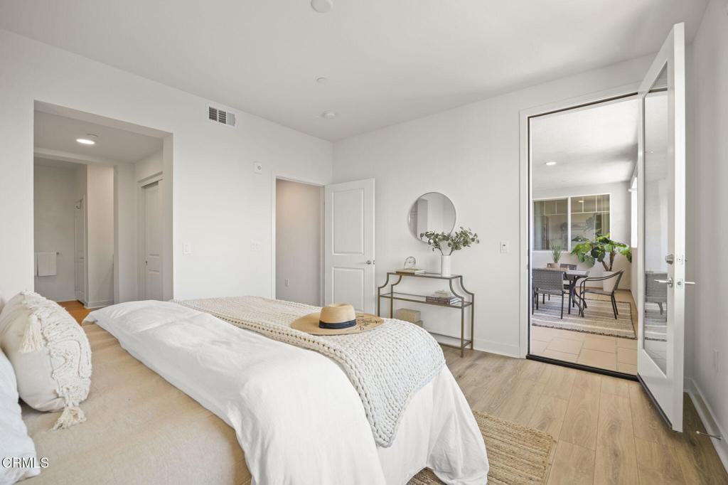 2870 Wagon Wheel Road, Unit 401 Oxnard, CA 93036 - Photo 29 of 49 a bedroom with a bed and a chandelier