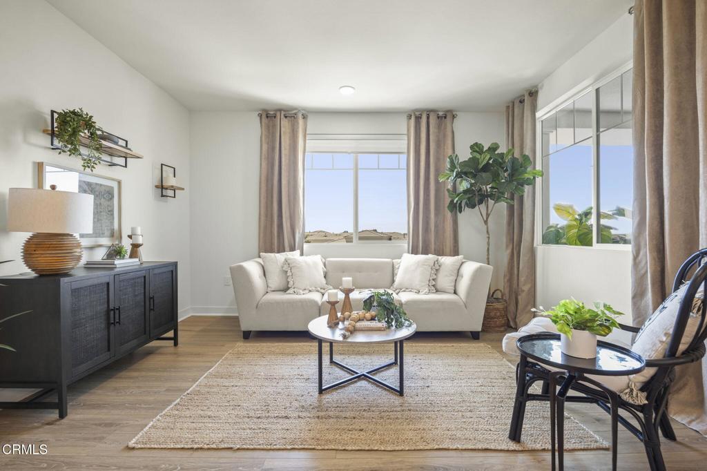 2870 Wagon Wheel Road, Unit 401 Oxnard, CA 93036 - Photo 6 of 49 a living room with furniture and a potted plant