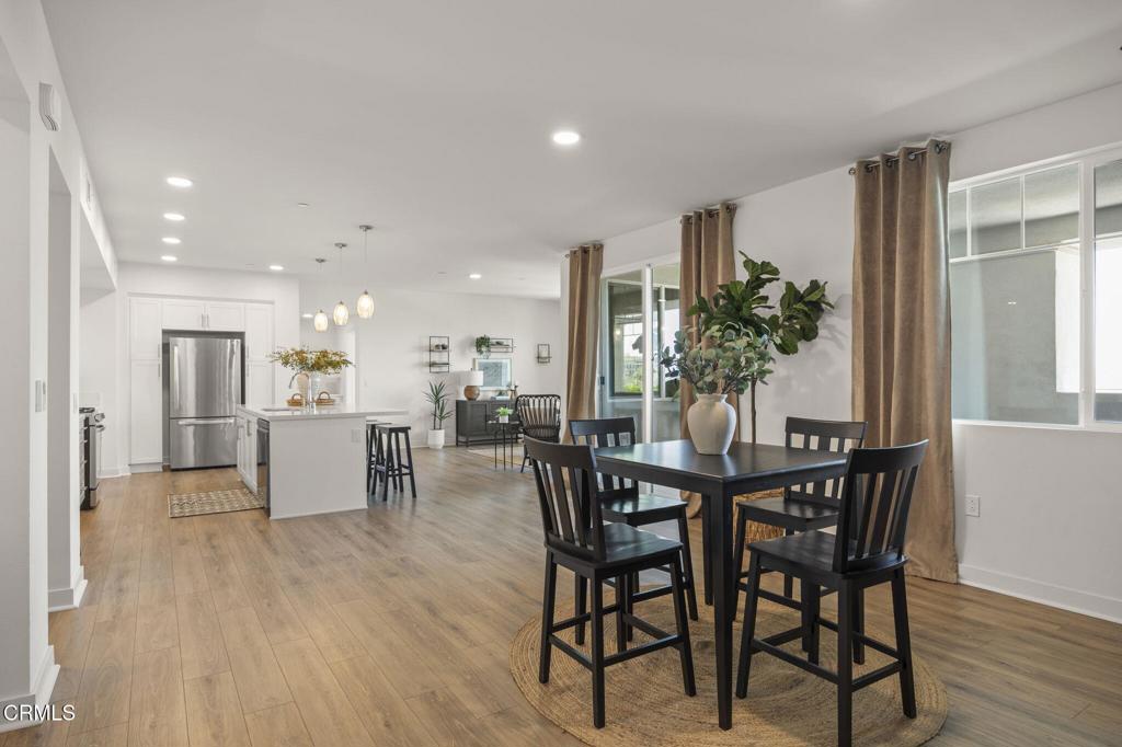 2870 Wagon Wheel Road, Unit 401 Oxnard, CA 93036 - Photo 7 of 49 a view of a dining room with furniture and wooden floor