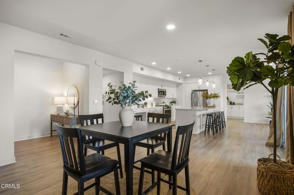 2870 Wagon Wheel Road, Unit 401 Oxnard, CA 93036 - Photo 8 of 49 a view of a dining room with furniture and wooden floor