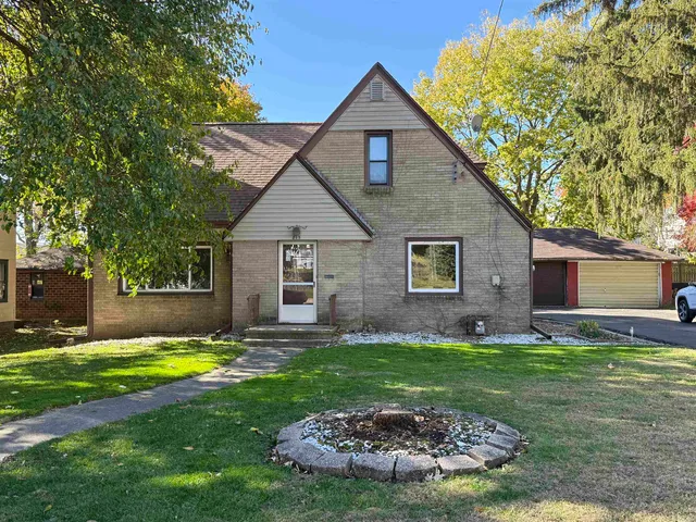 a view of a house with a yard and swimming pool