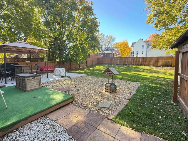 a view of a backyard with sitting area