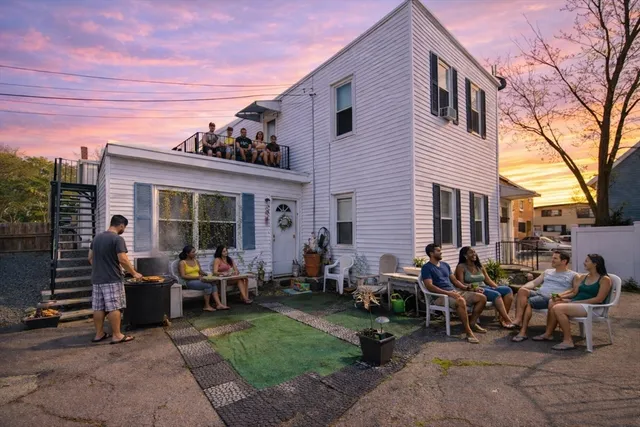 a view of a house with backyard and sitting area