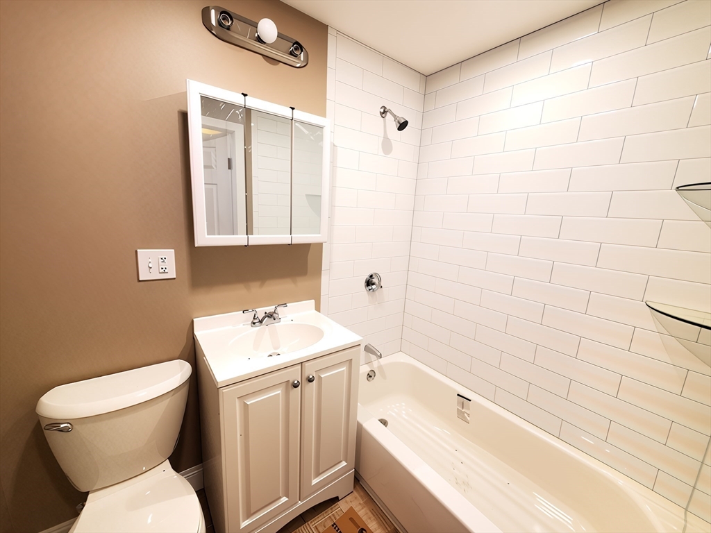 84 Cross Street Somerville, MA 02145 - Photo 12 of 42 a bathroom with a sink toilet and shower