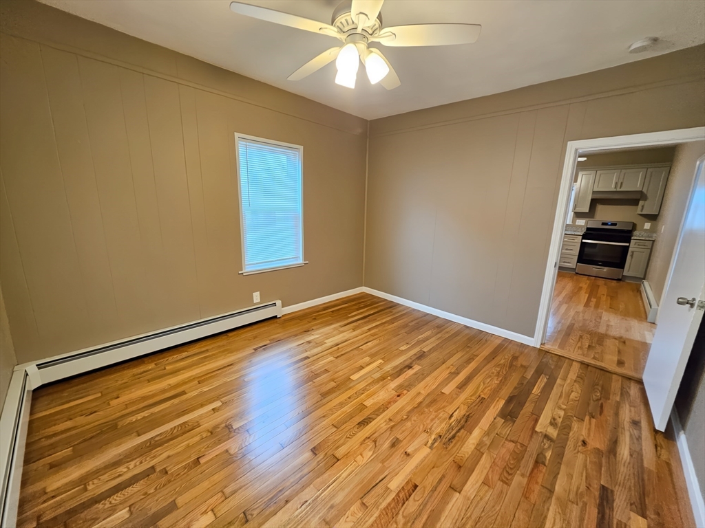 84 Cross Street Somerville, MA 02145 - Photo 20 of 42 a view of an empty room with wooden floor and a window