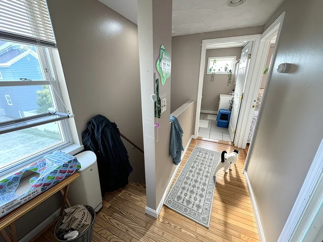 a kitchen with a refrigerator and white cabinets