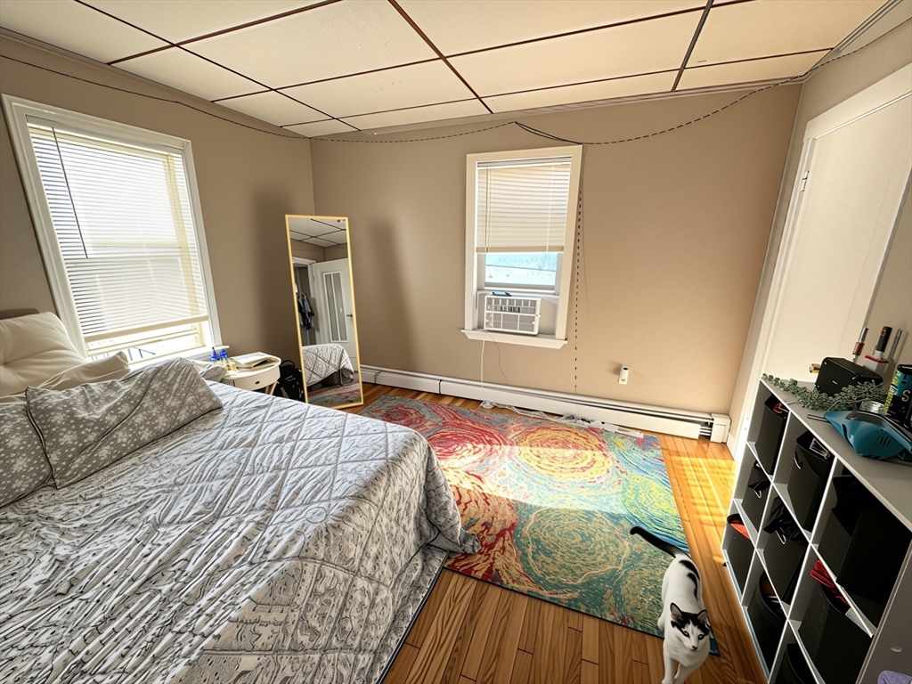 84 Cross Street Somerville, MA 02145 - Photo 38 of 42 a bedroom with a bed and a window