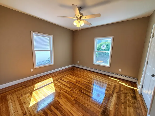 a kitchen with stainless steel appliances granite countertop a refrigerator a sink dishwasher a stove and white countertops with wooden floor