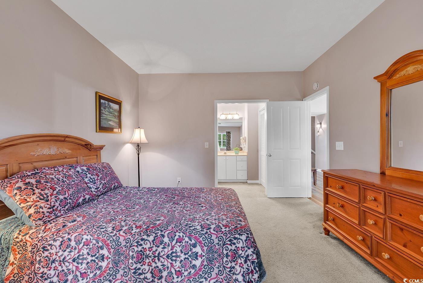 4608 Arran Court, Unit E Myrtle Beach, SC 29579 - Photo 13 of 39 Carpeted bedroom featuring a textured ceiling