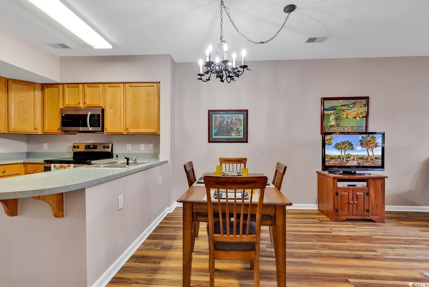 4608 Arran Court, Unit E Myrtle Beach, SC 29579 - Photo 6 of 39 Dining space with ceiling fan with notable chandel