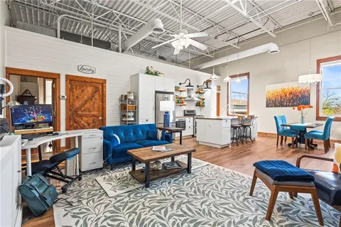 a living room with furniture a rug and a chandelier