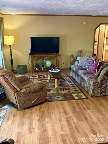 a living room with fireplace furniture and a floor to ceiling window