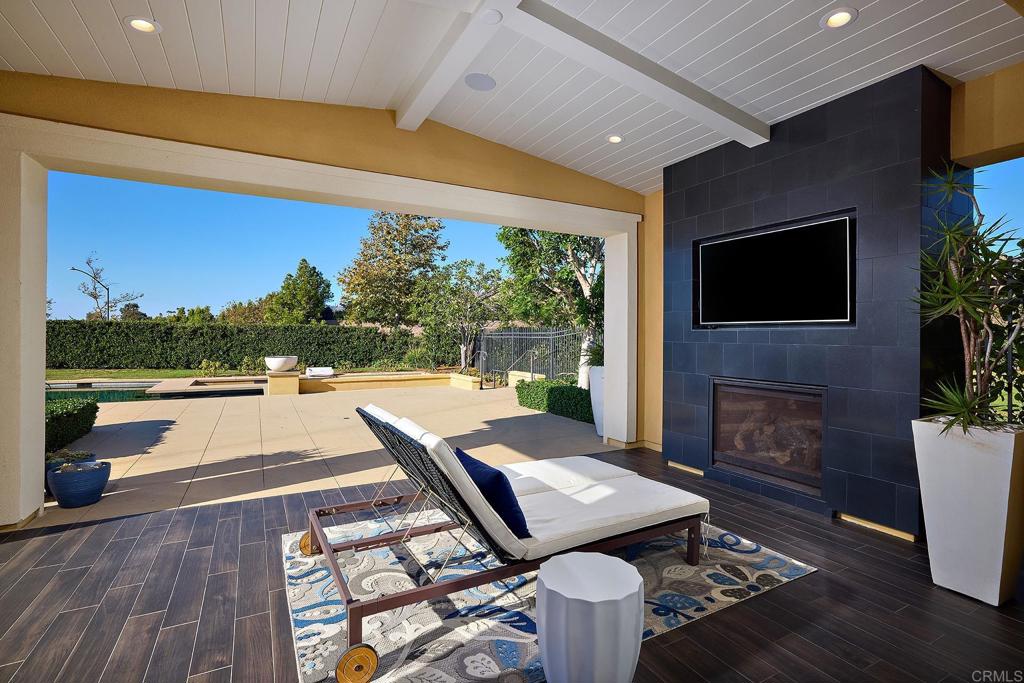 15527 Artesian Ridge San Diego, CA 92127 - Photo 13 of 25 a view of a patio with couches table and chairs with wooden floor