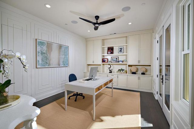 a living room with stainless steel appliances furniture and a window