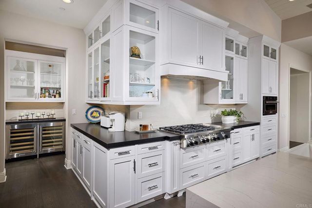 a kitchen with stainless steel appliances a stove and cabinets