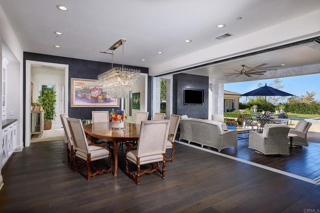 a dining room with furniture window and wooden floor