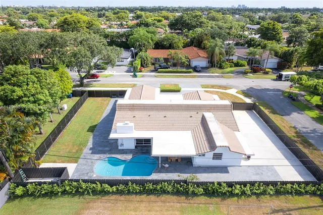 an aerial view of a house with swimming pool