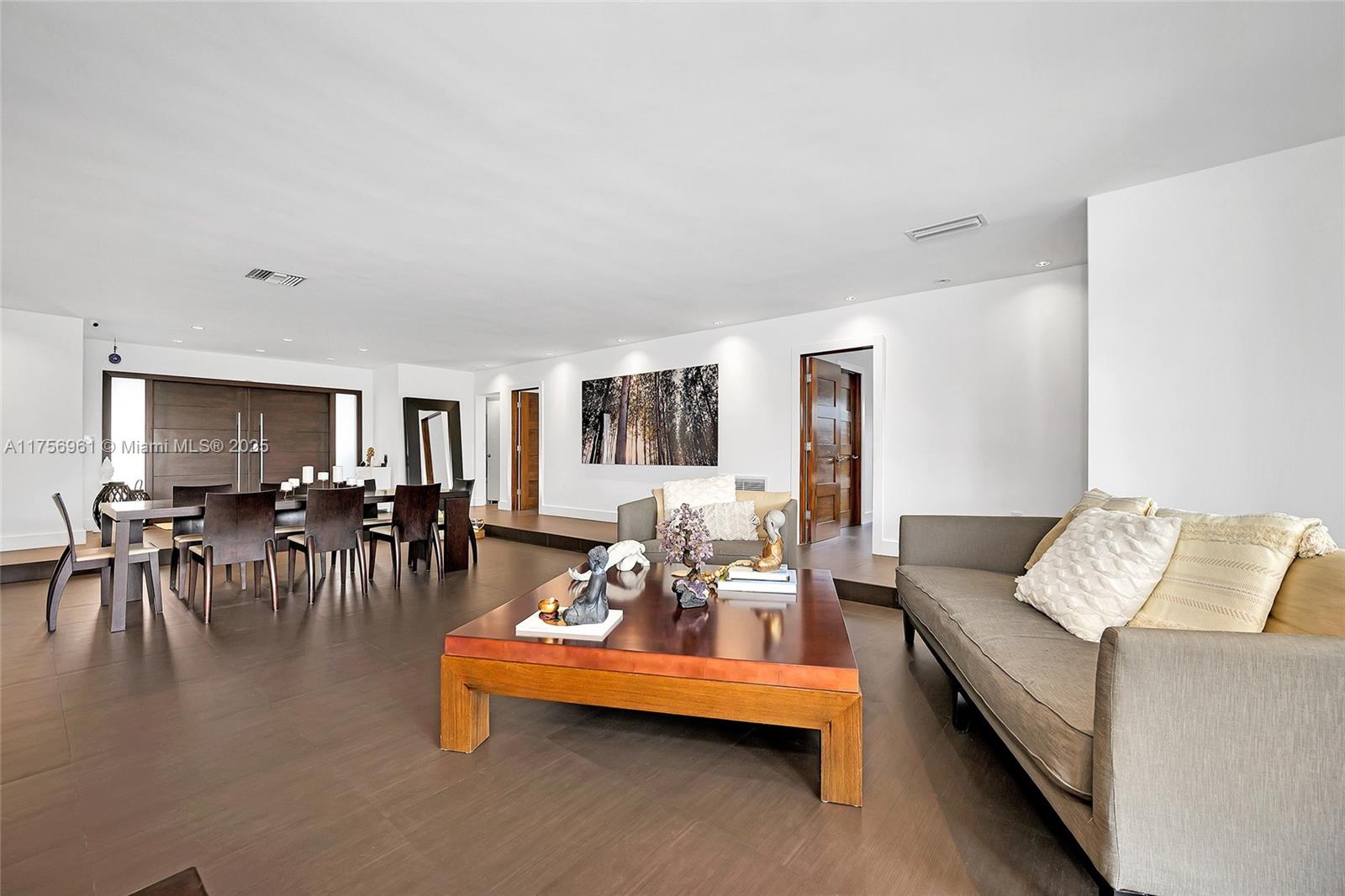 2120 Northeast 204th Street Miami, FL 33179 - Photo 12 of 52 a living room with furniture and a dining table with wooden floor