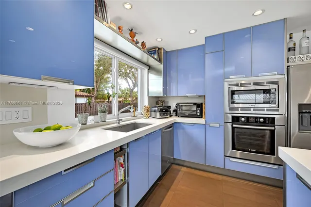 a kitchen with stainless steel appliances a stove a refrigerator and cabinets