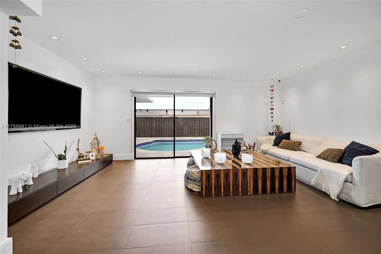 2120 Northeast 204th Street Miami, FL 33179 - Photo 22 of 52 a living room with furniture and a flat screen tv