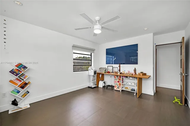 a bedroom with a bed and a tv on table
