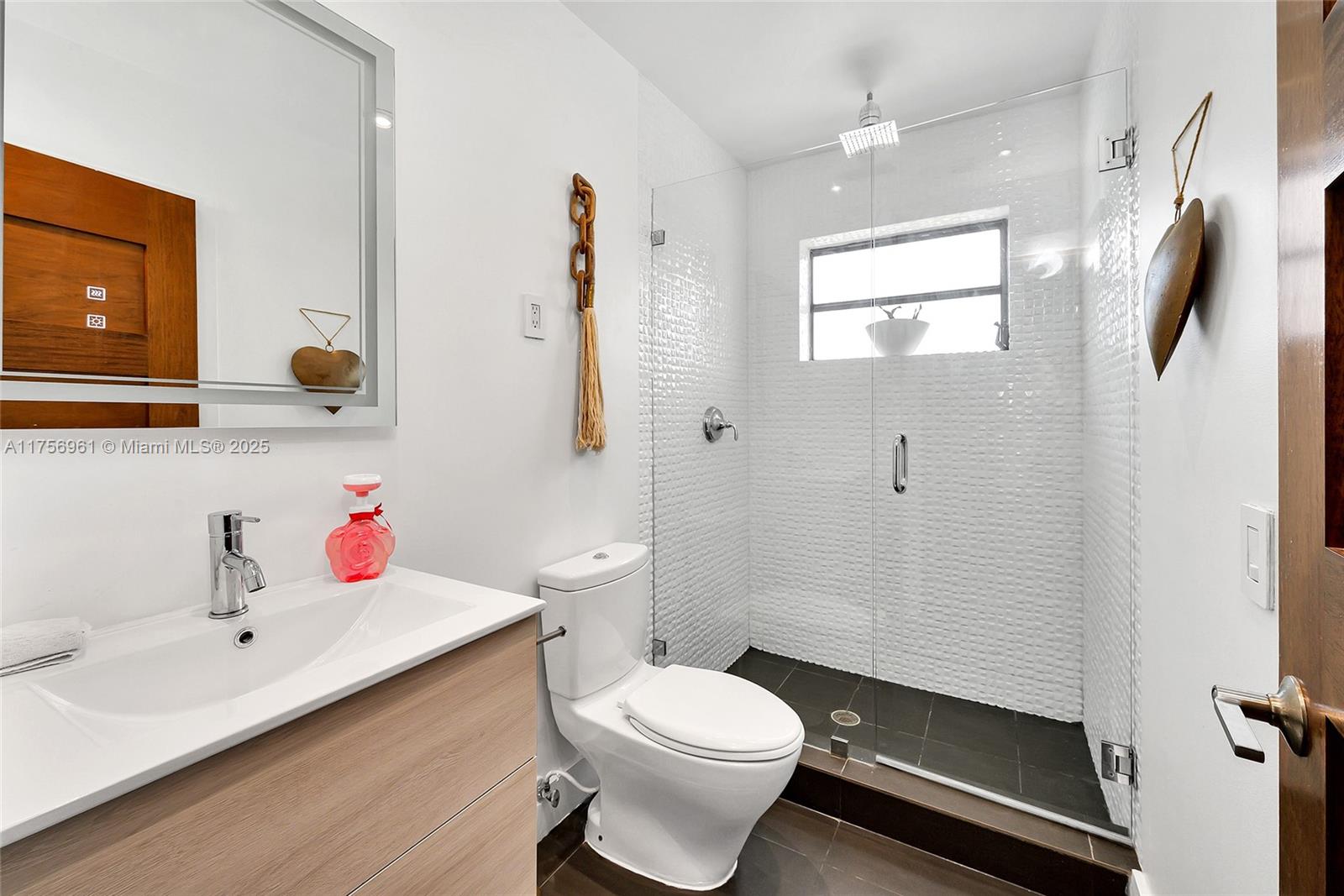 2120 Northeast 204th Street Miami, FL 33179 - Photo 26 of 52 a bathroom with a sink toilet and shower